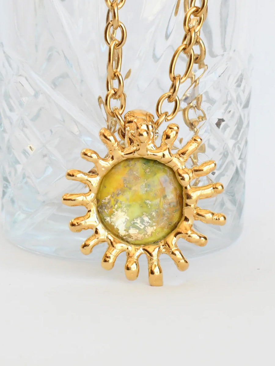 Close up of Be Em gold sun necklace
