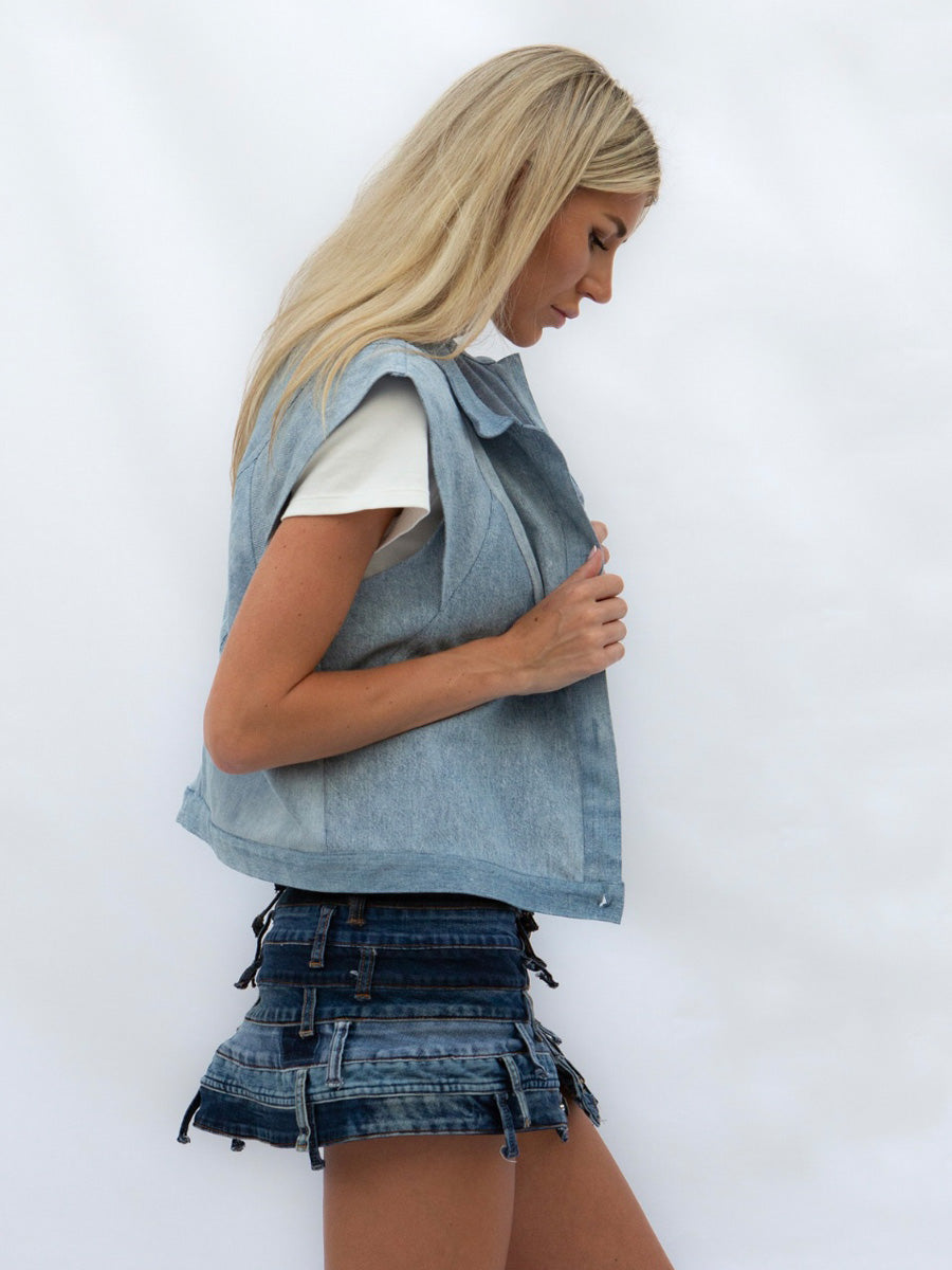 Blonde woman outside wearing Dunesi denim jacket and skirt